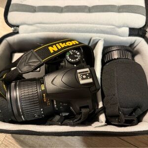 Nikon Black DSLR Camera with Yellow-Accented Strap and Black Lens